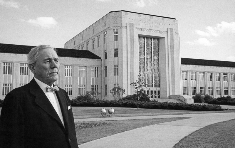 picture of Hugh Roy Cullen standing in front of the Ezekiel Cullen Building