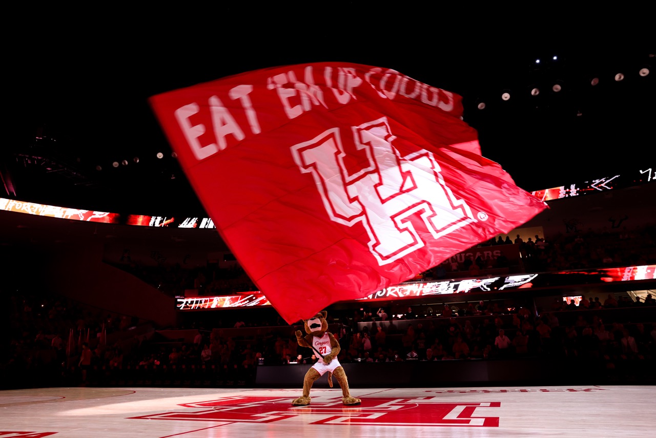 UH Shasta holding Eat Em Up Flag