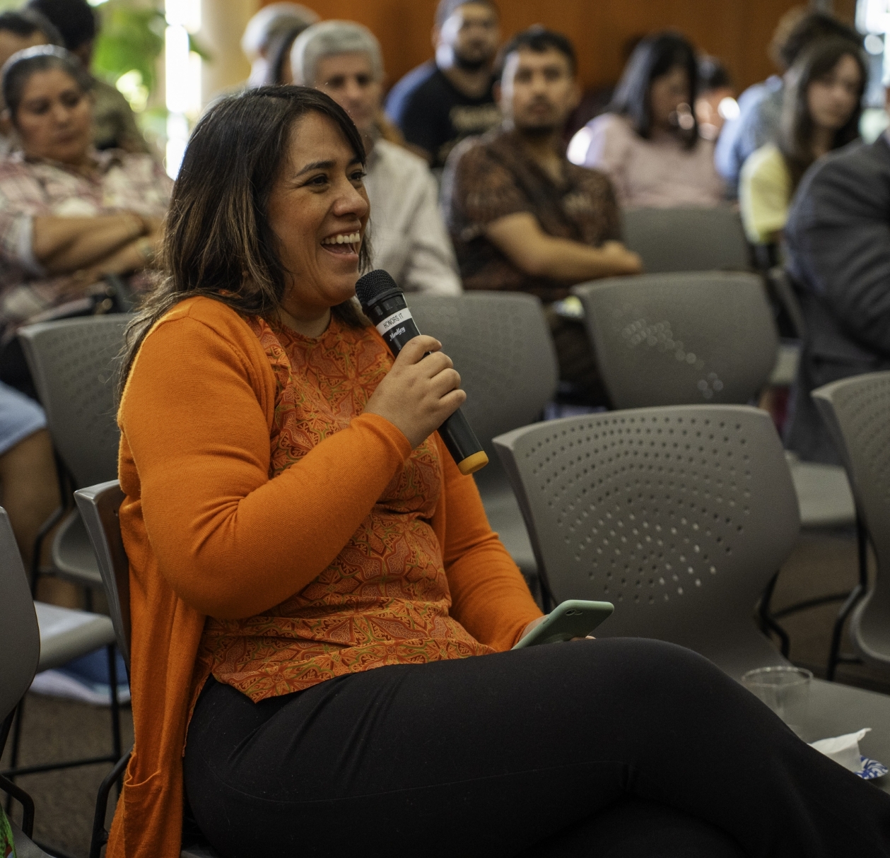 A professor speaks into a microphone