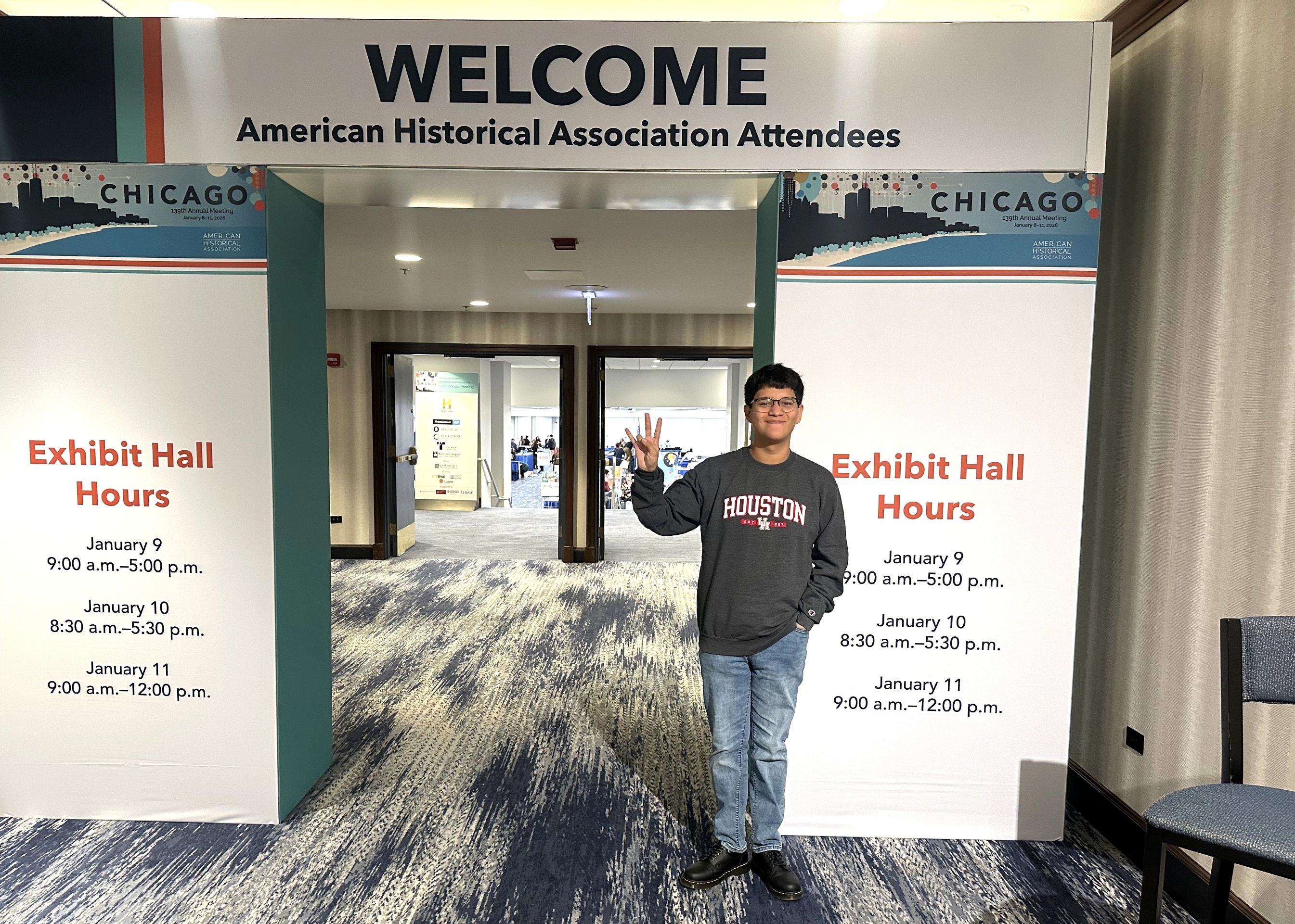 A student stands in an exhibition hallway