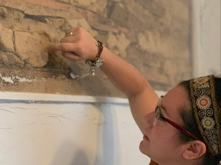 Trabucco points out the various ingredients visible for the mixture of adobe that was used and meets homeowners of an adobe household who exposed the wall of their home.