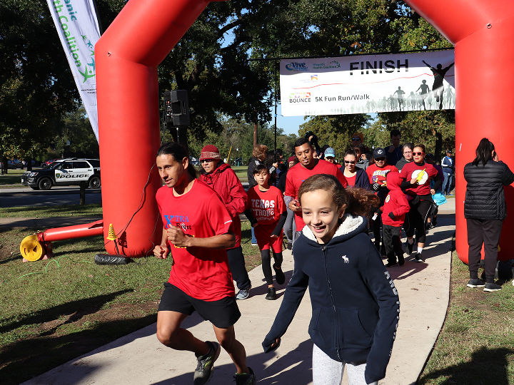 Adults and a child completing a race