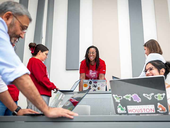 Ed.D. students collaborate around laptops during a classroom workshop.