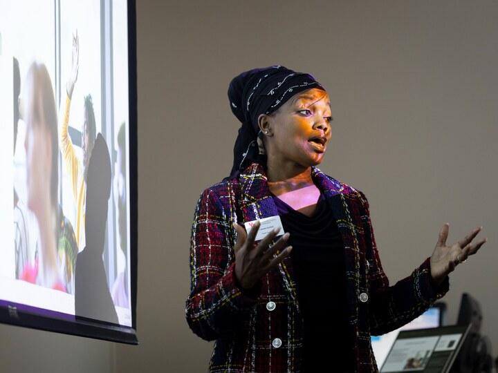 Ed.D. student presents research to classmates in front of a projected slide