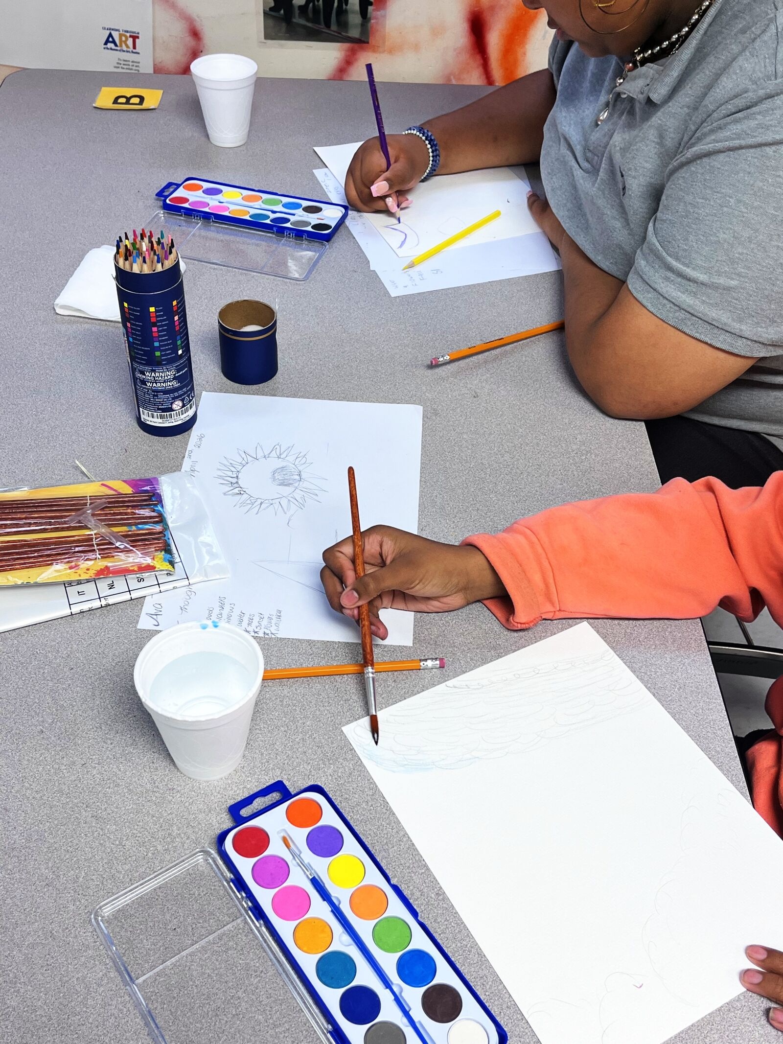 zoomed in image of student painting with water color