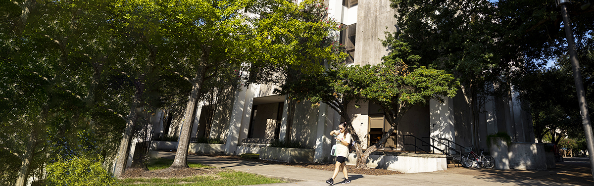 McElhinney Building with a female student walking in front of it