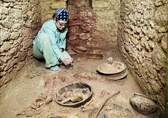 Dr Chase digging in tomb