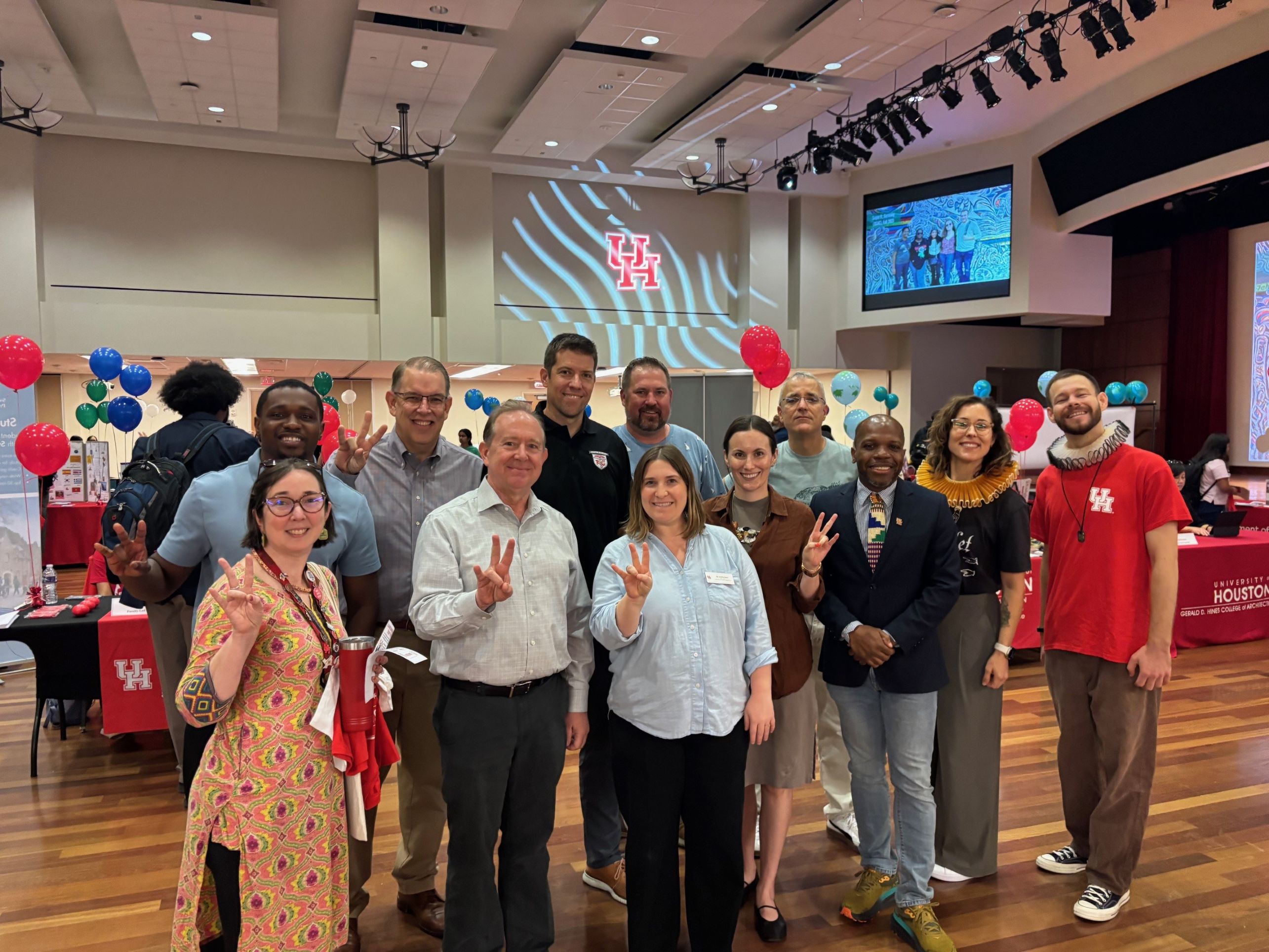 photo of faculty posing for a photo at the Learning Abroad fair