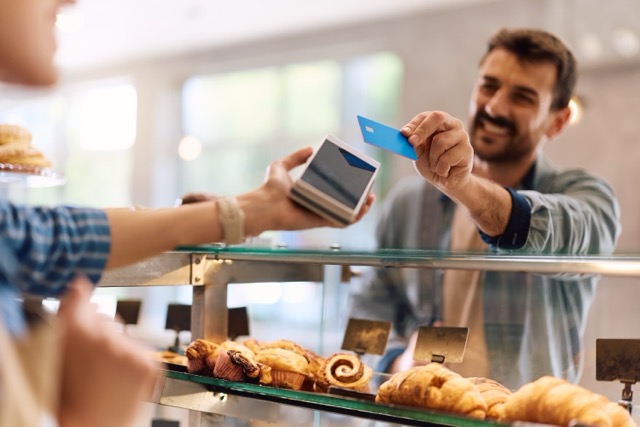  Man purchacing product with a credit card