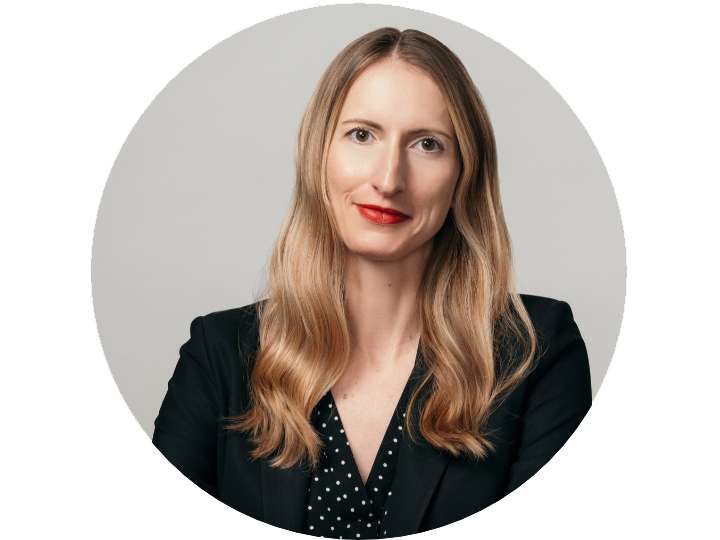 female professor in a black blazer and black and white poka dot shirt