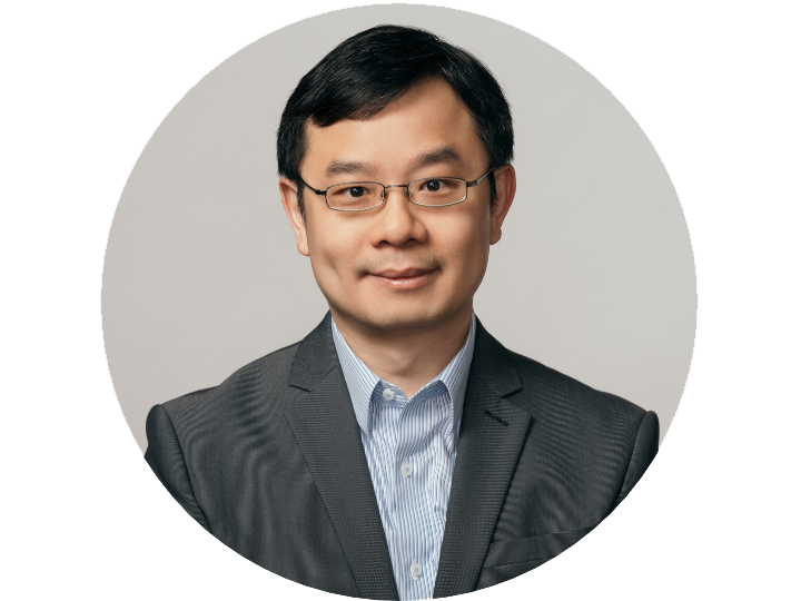 male professor in a grey sports jacet and light blue shirt