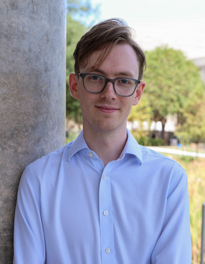 Middle age man in a white shirt with glasses