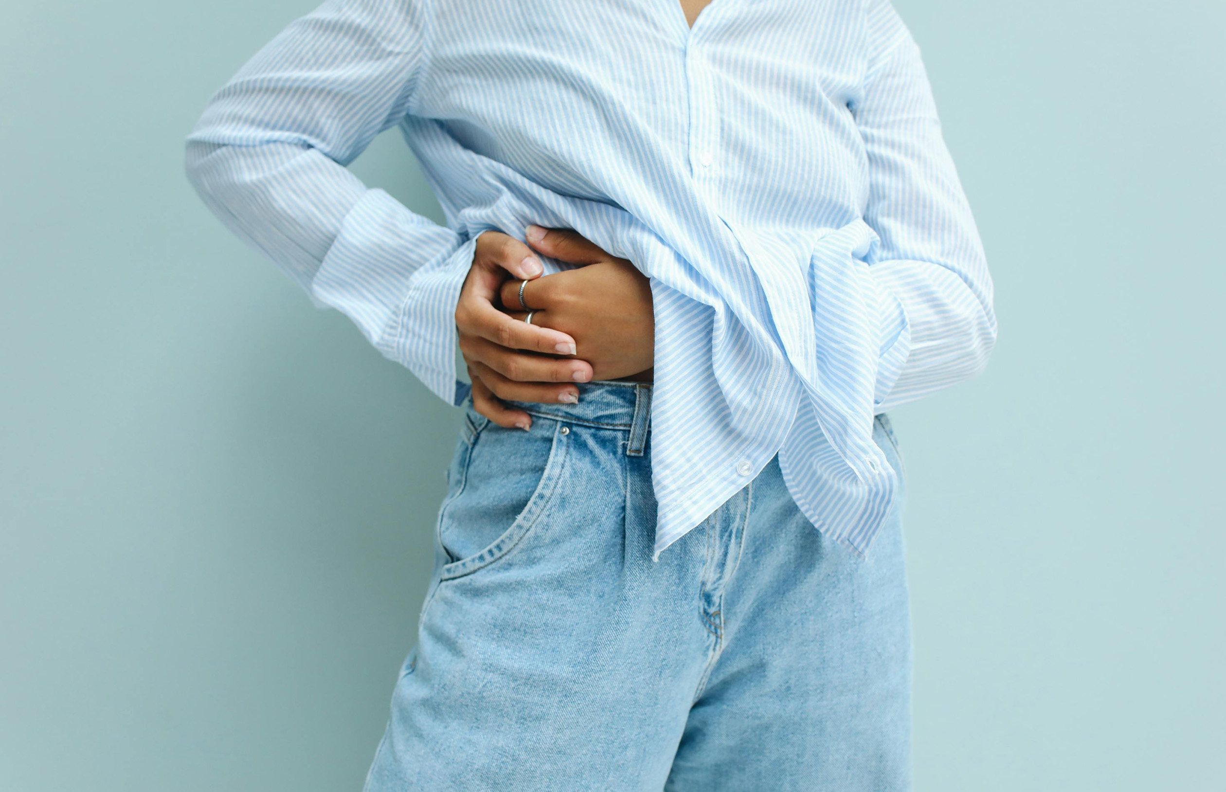 Person grabbing their side with liver pain.