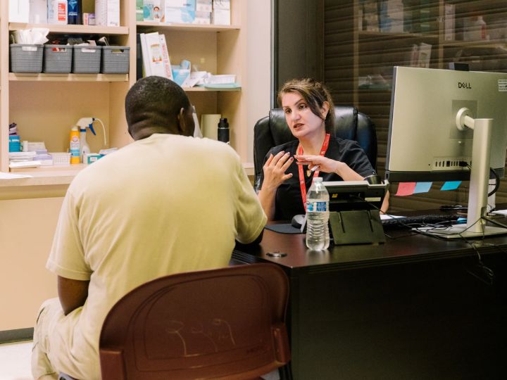Nurse speaking with patient at clinic