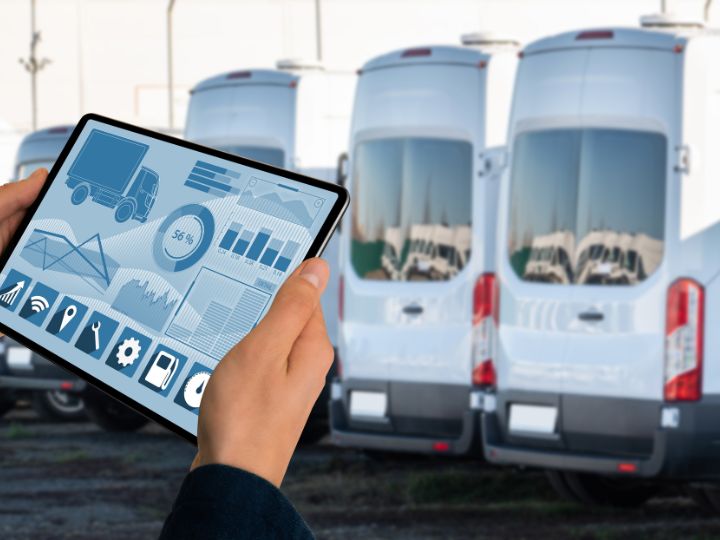 Person with computer in front of a fleet of cars for carbon management