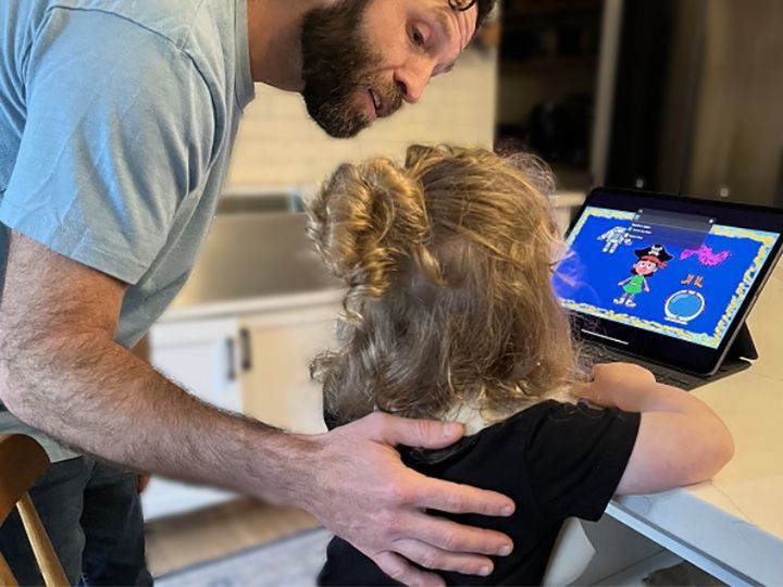 Caregiver and toddler with iPad