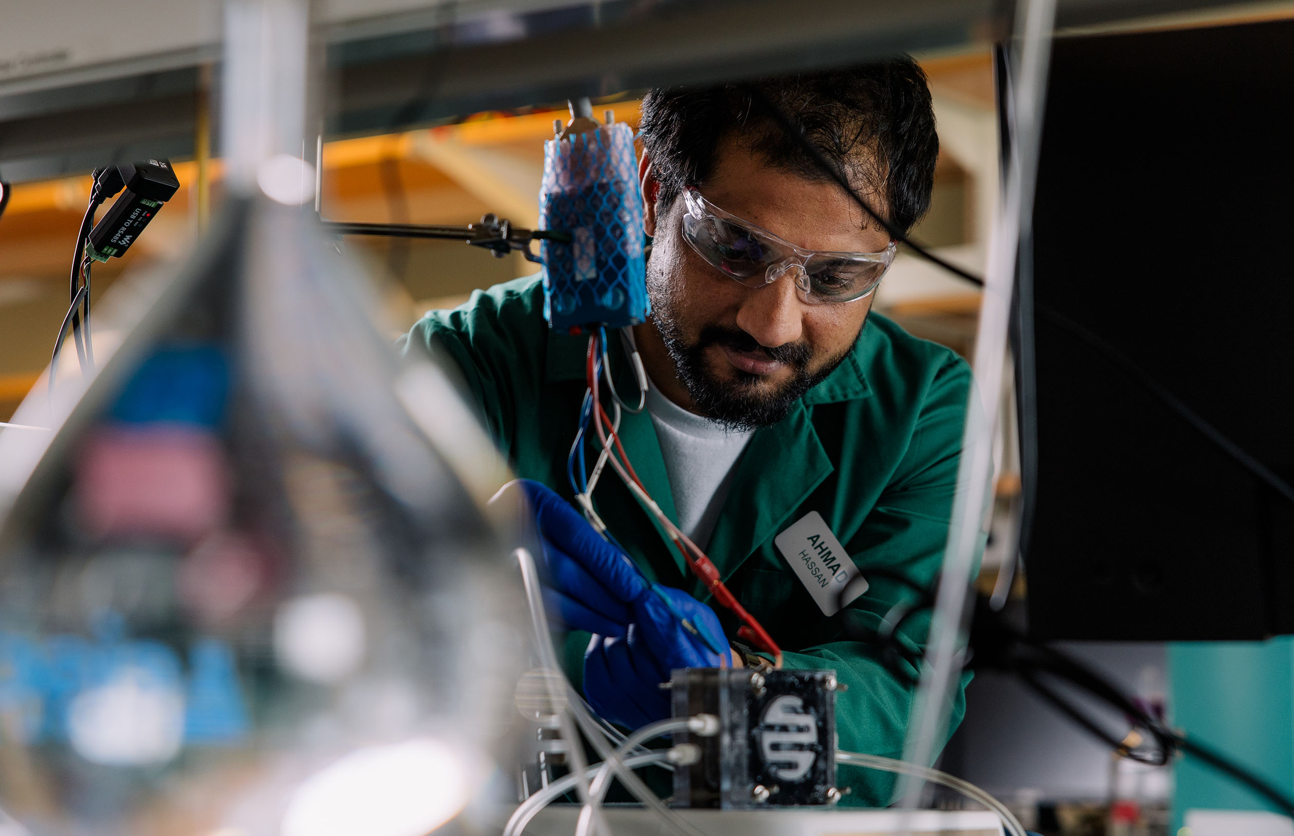 Doctoral Student Ahmad Hassan works on the carbon capture device.