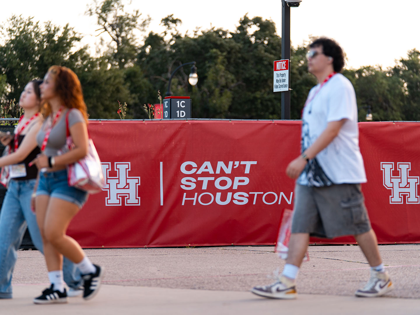 Students walking past Can’t Stop Houston banner