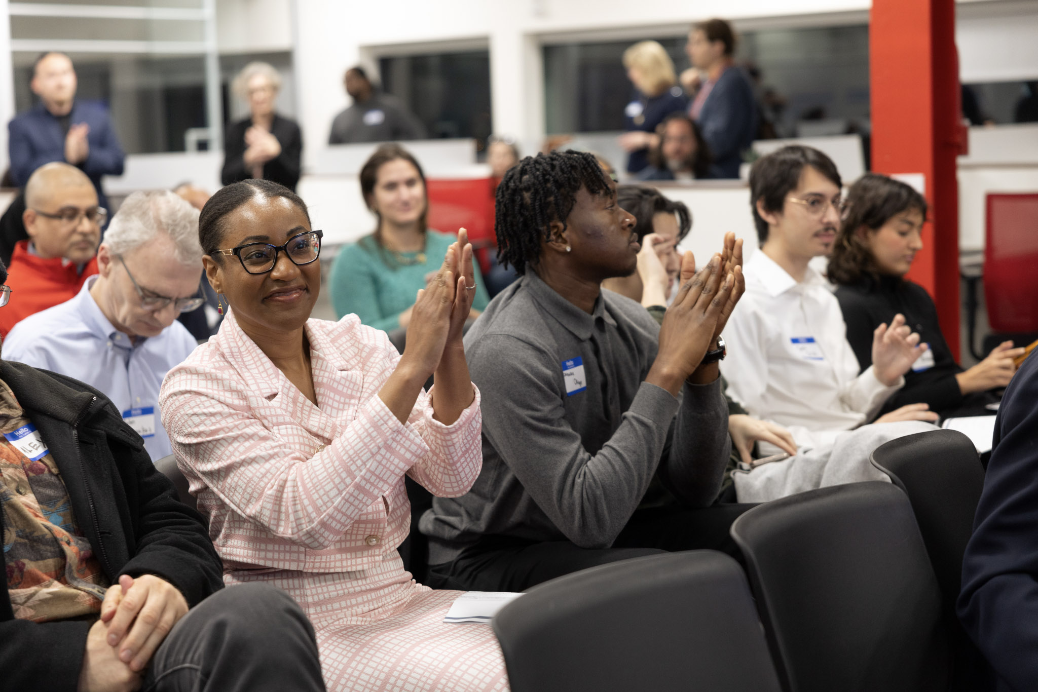 This is a photo of Victoria Mgbemena clapping with her peers. 