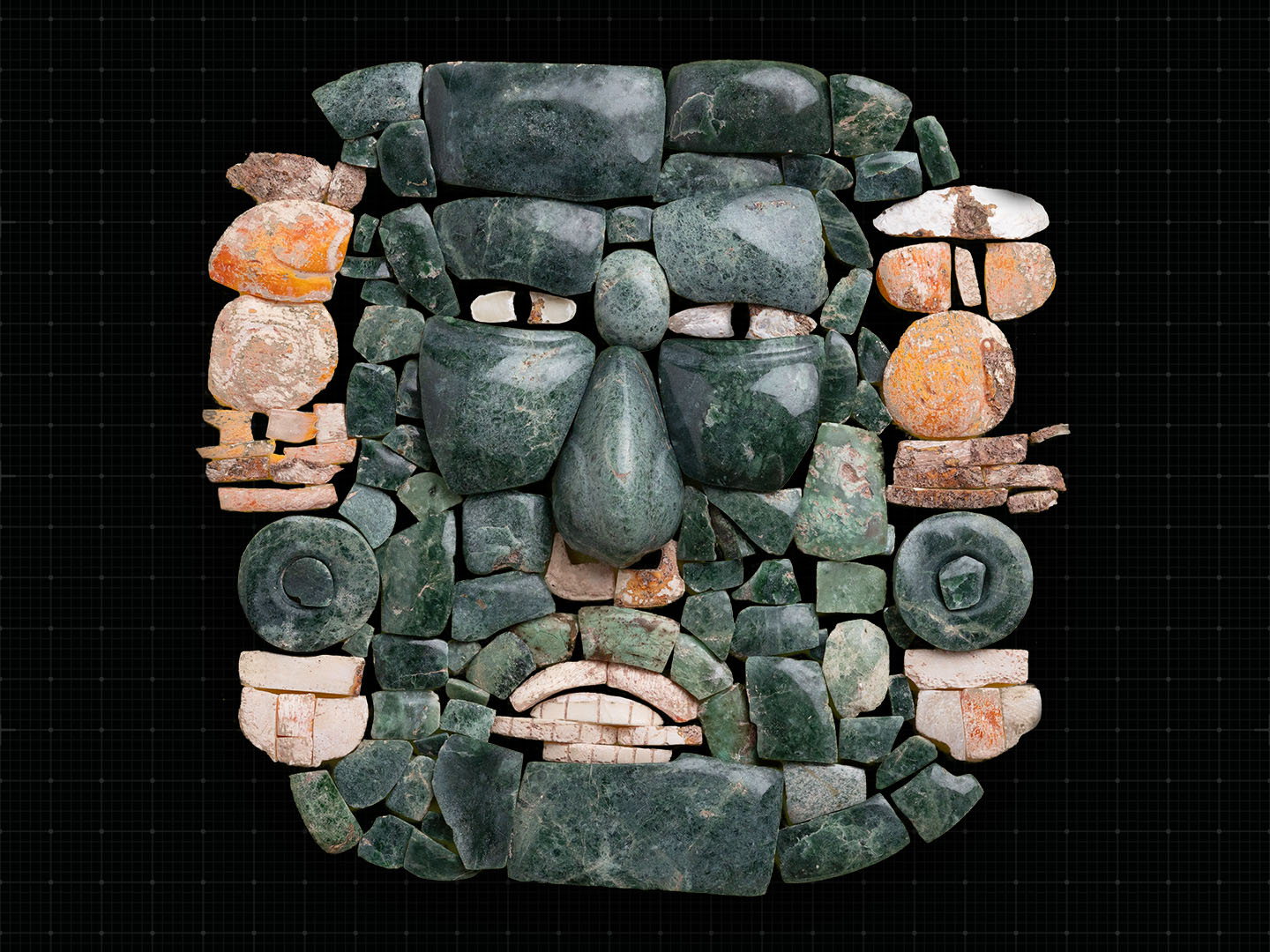 Close-up of pieces of an ancient mask arranged together