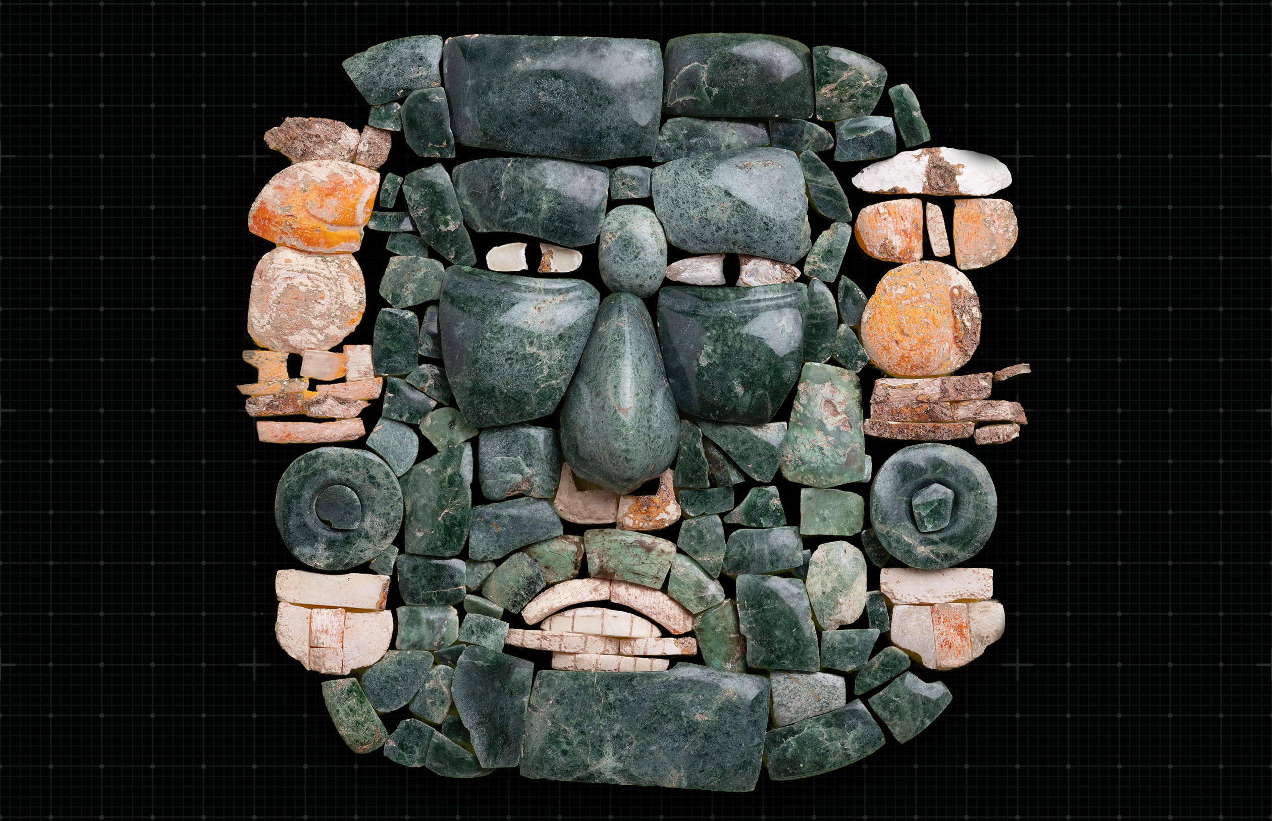 Close-up of pieces of an ancient mask arranged together