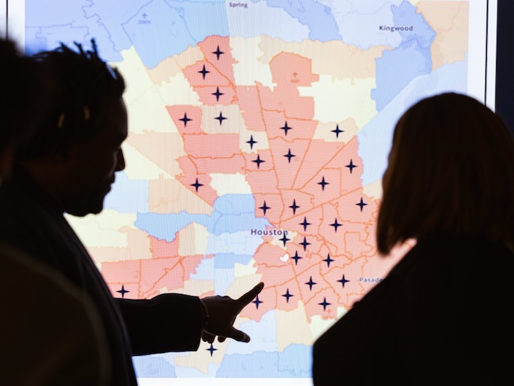 shadowed image of chakema carmack and damien kelly standing in front of a mental health map