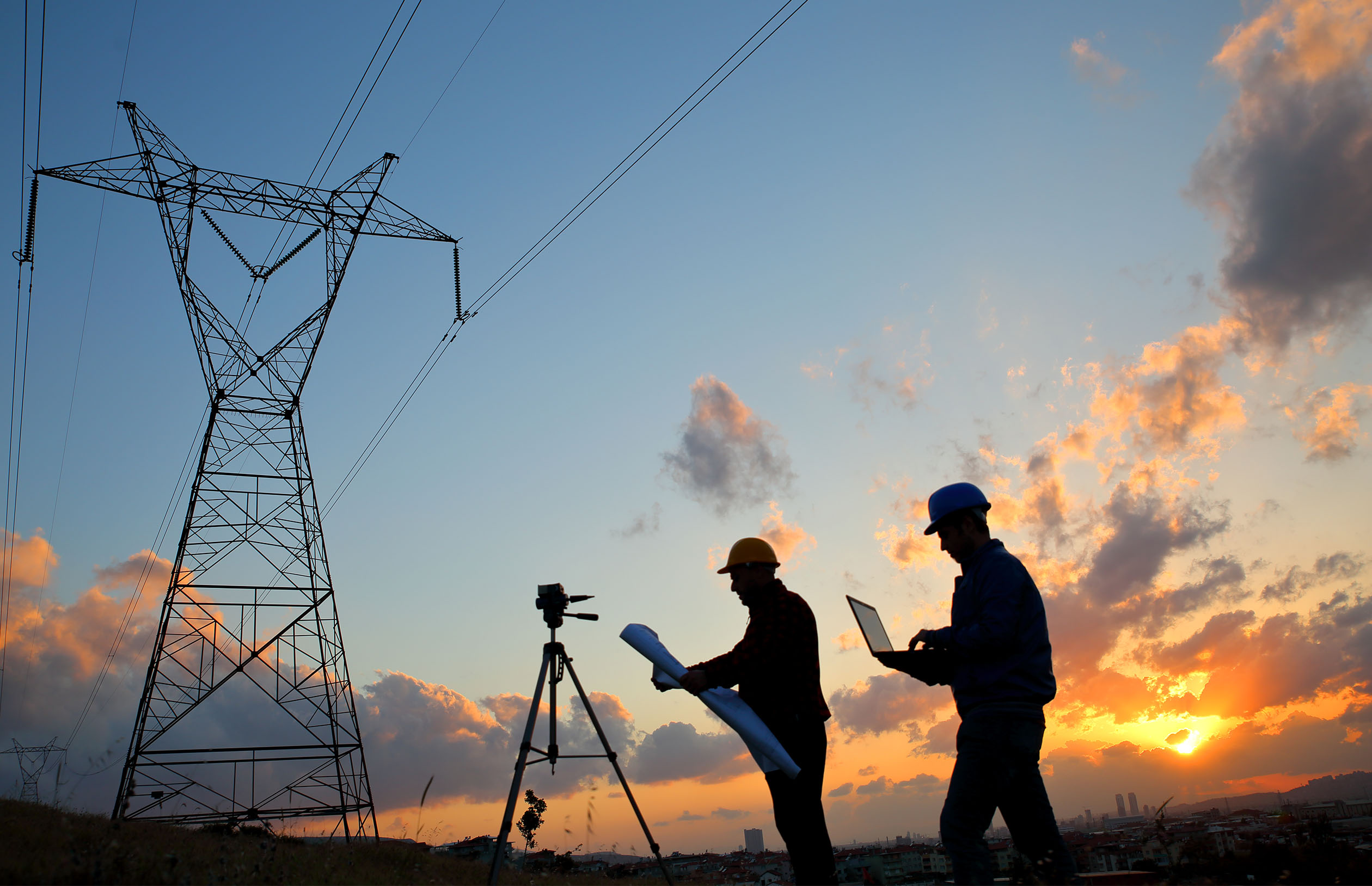 getty image of workers around power line towers