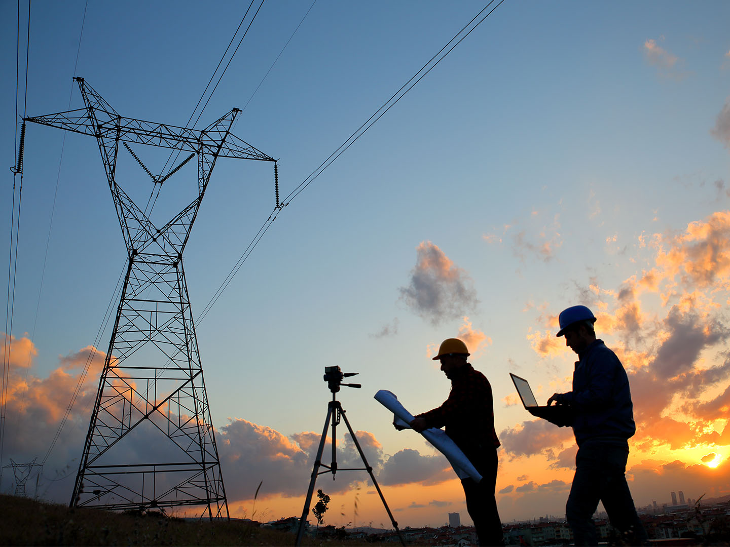 getty image of workers around power line towers