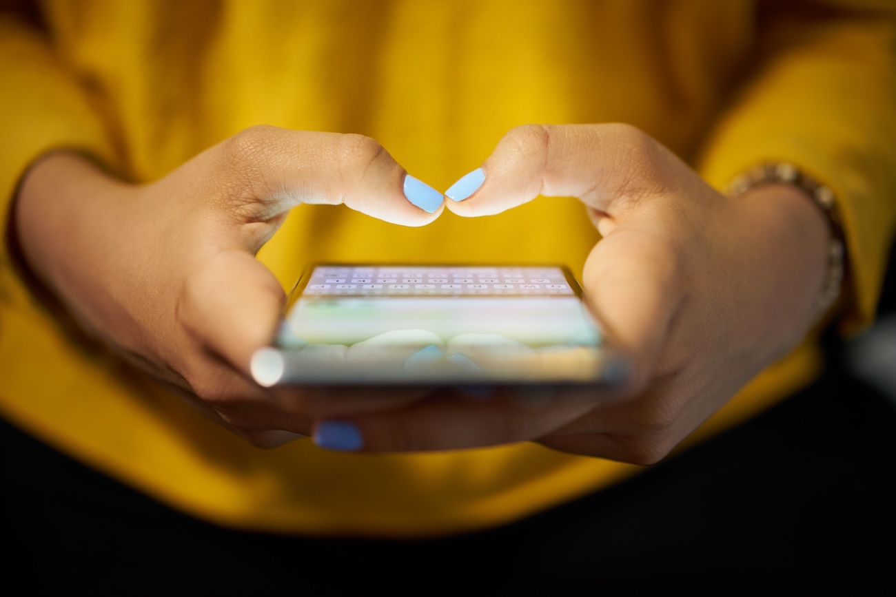 Hands holding phone getting ready to type
