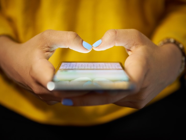 Hands holding phone getting ready to type