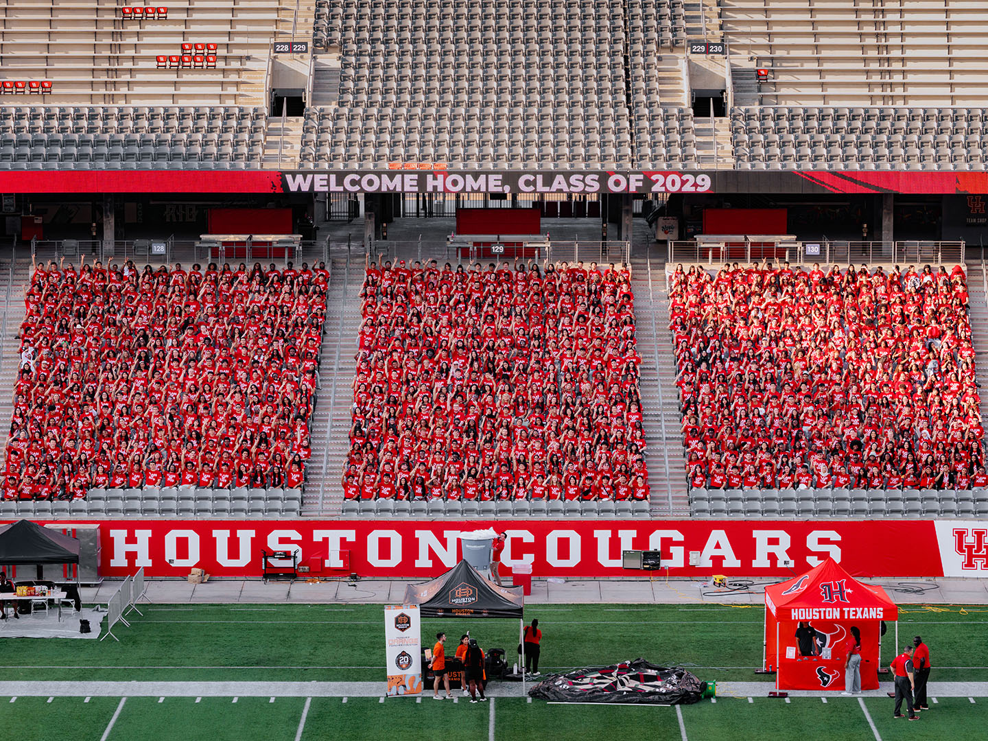 Group photo of hundreds of students making up the University of Houston class of 2029 joined together in the stands of TDECU Stadium.