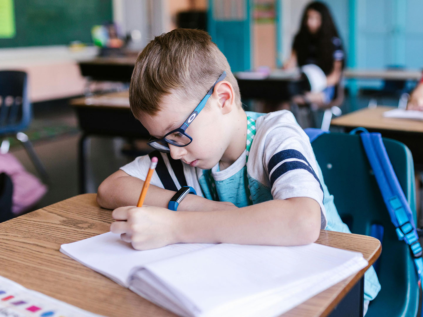 Children with glasses in a classroom.