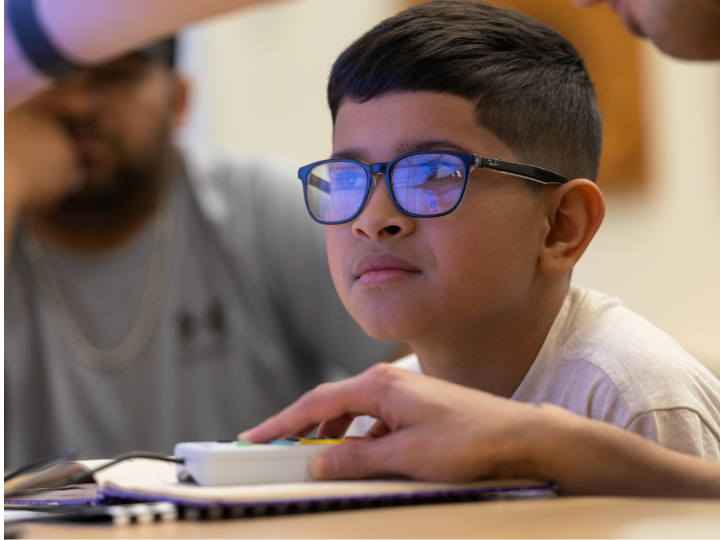 child working on a new visual enhancement device