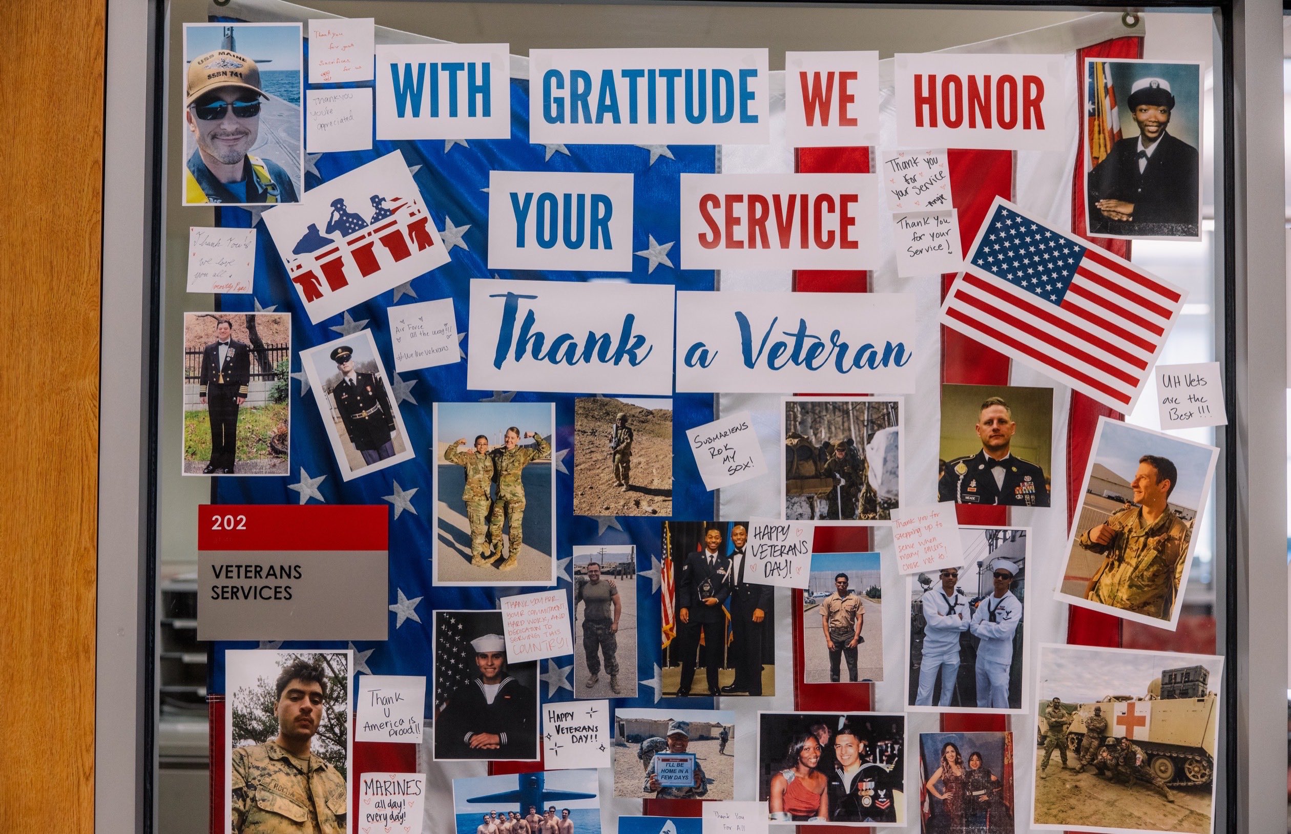 Window with photos of veterans and messages of gratitude.