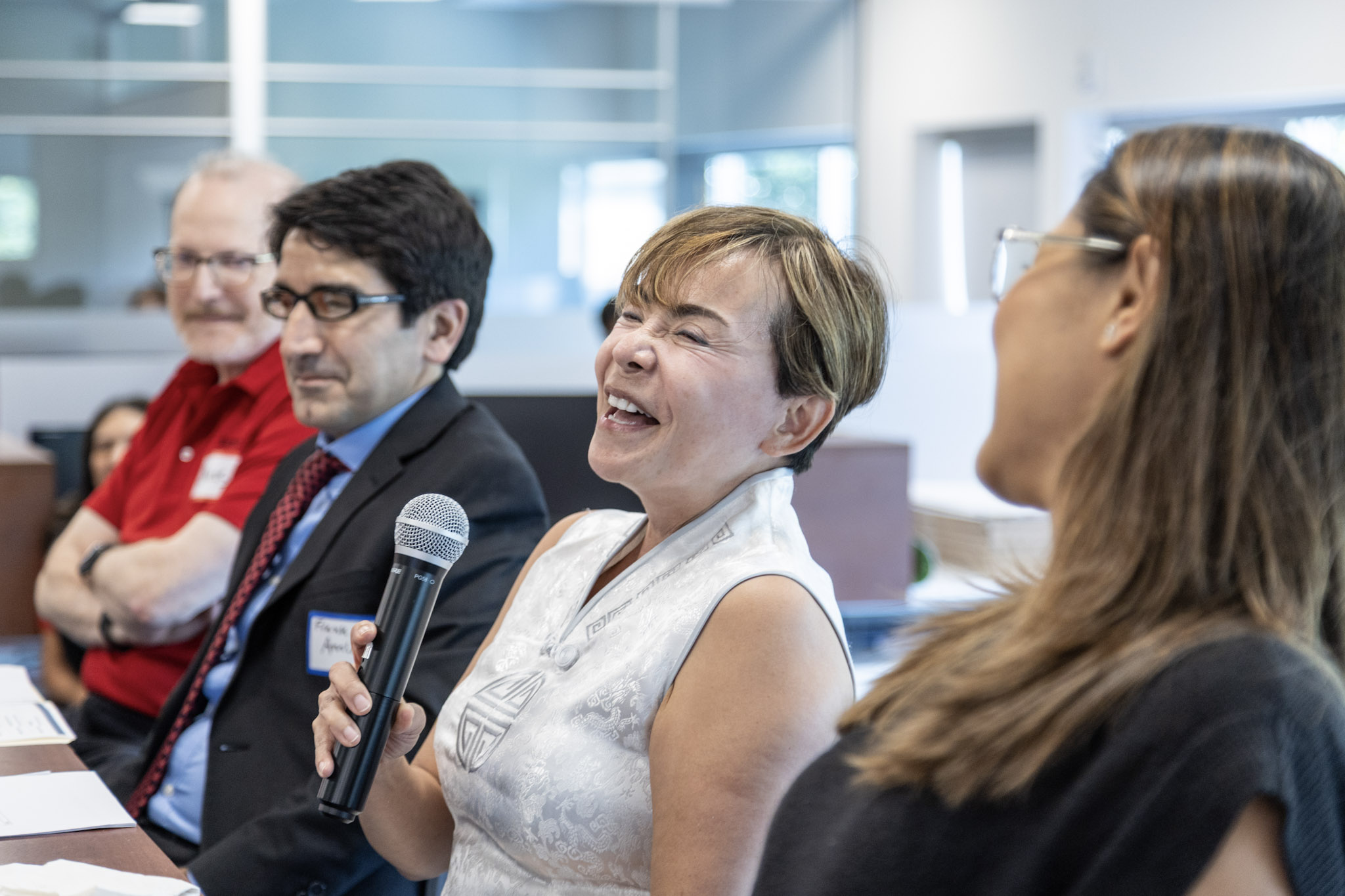 This is a photo of Impavious Managing Partner Amy Tran laughs with her fellow judges at the Startup Pitch Competition.
