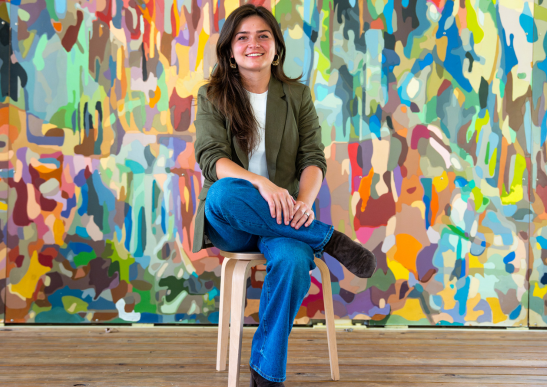 Image of Zoie Buske smiling and sitting down in the Folly.