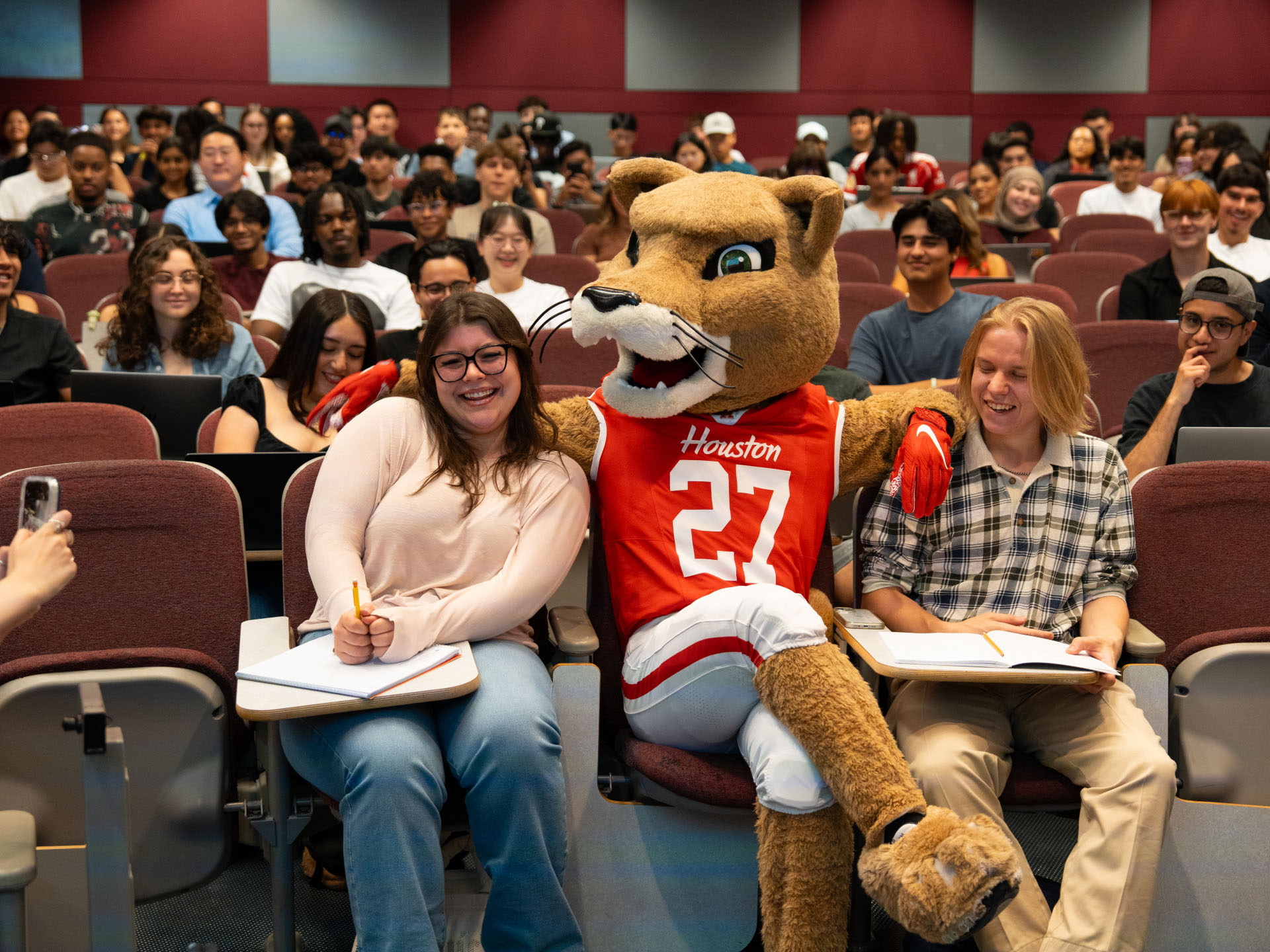 shasta posing with students at bauer college