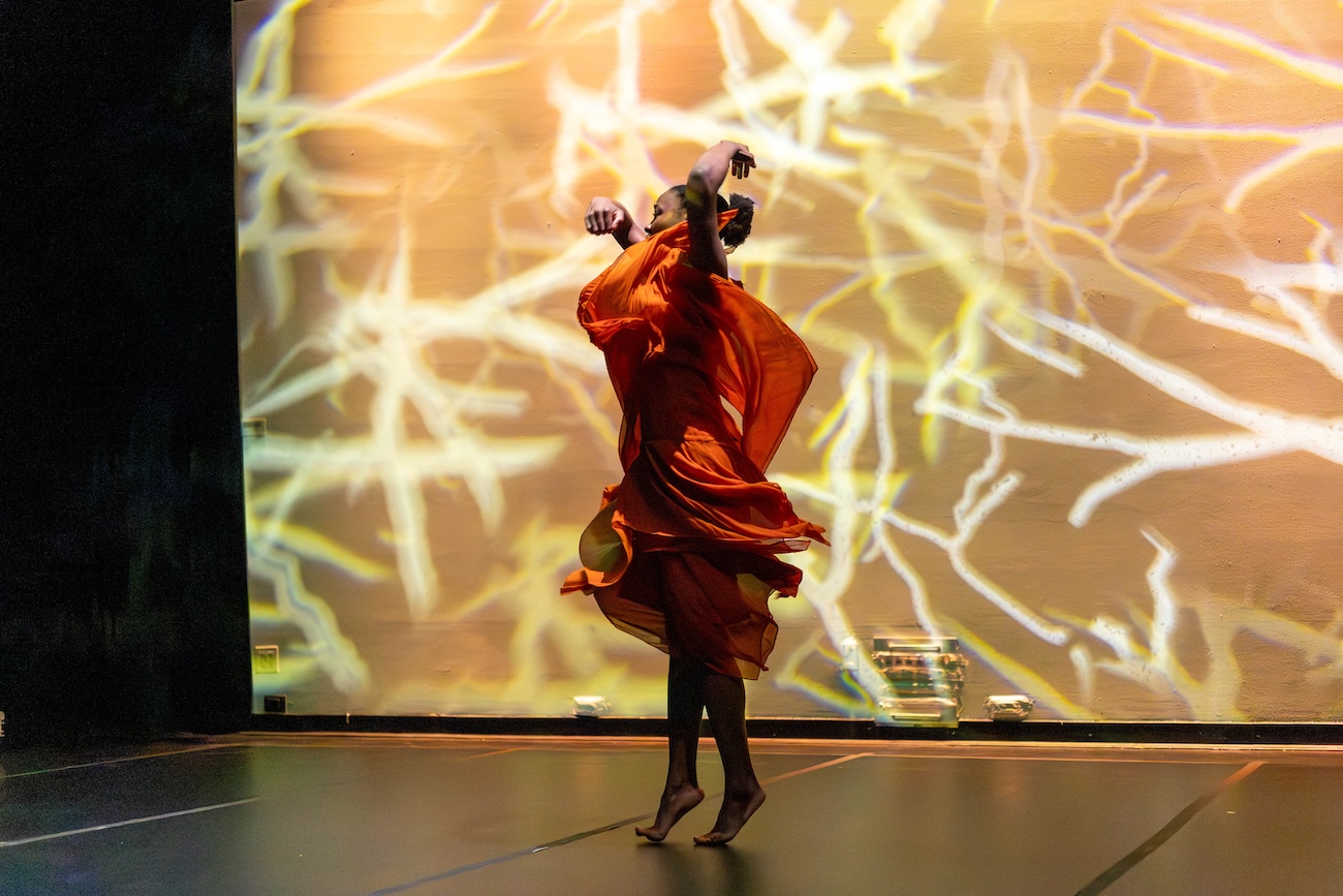 image of kgmca student dancing in front of a screen