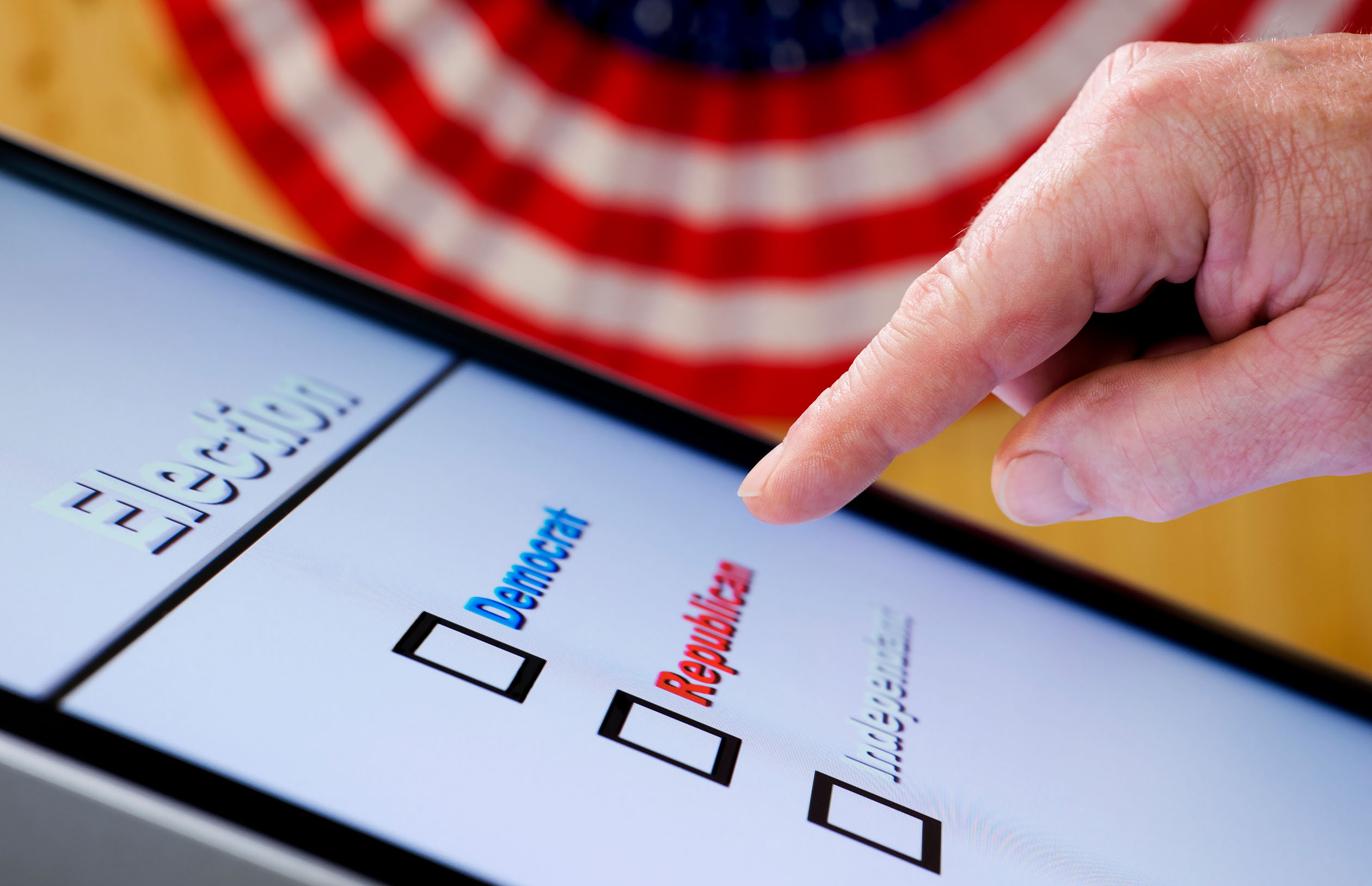 Finger hovering over republican button on ballot