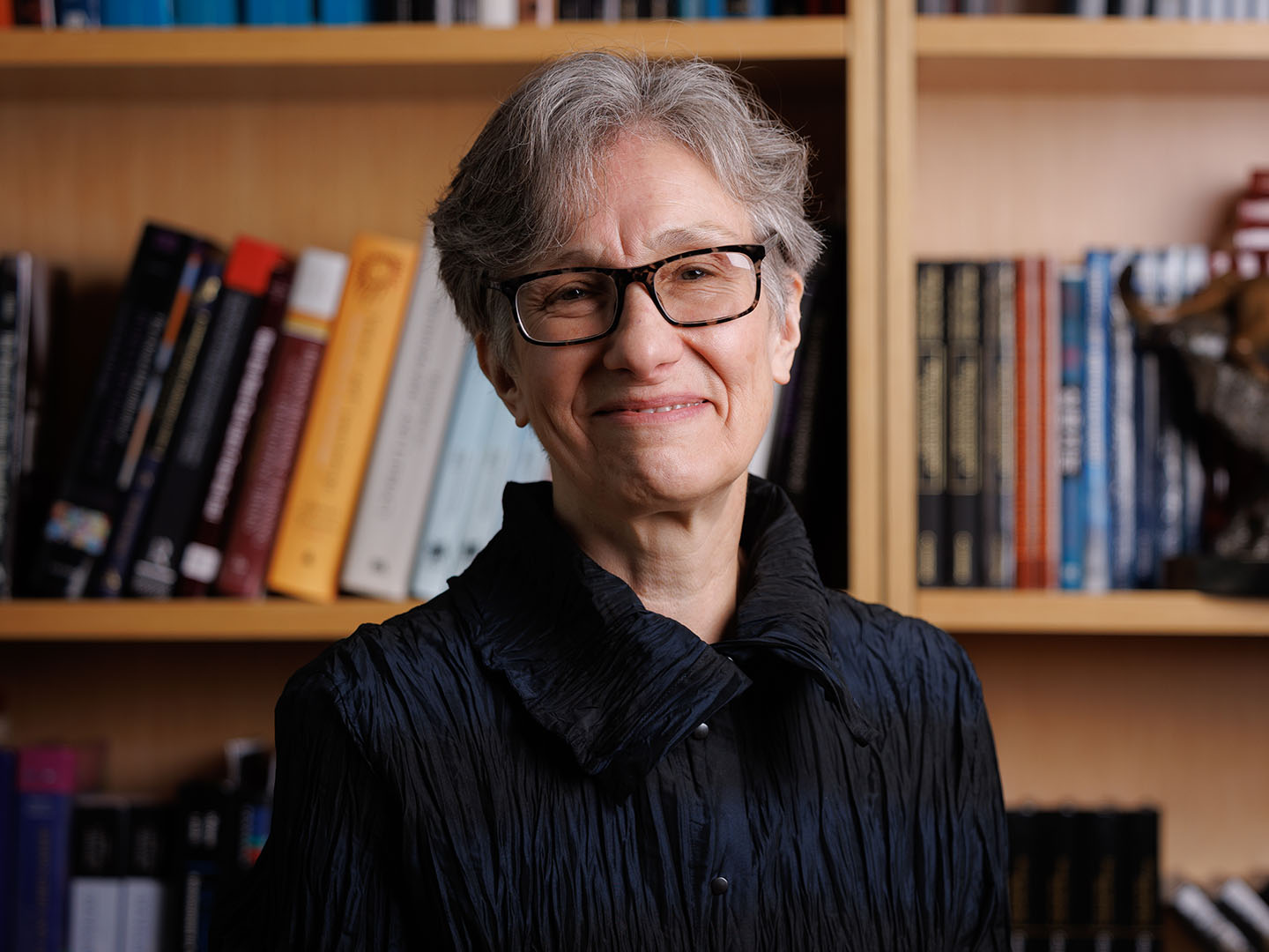 Professor Grigorenko smiling for a headshot in front of a bookshelf