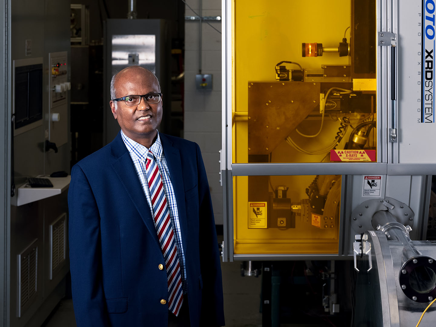 Venkat Selvamanickam wearing a suit in a research lab.