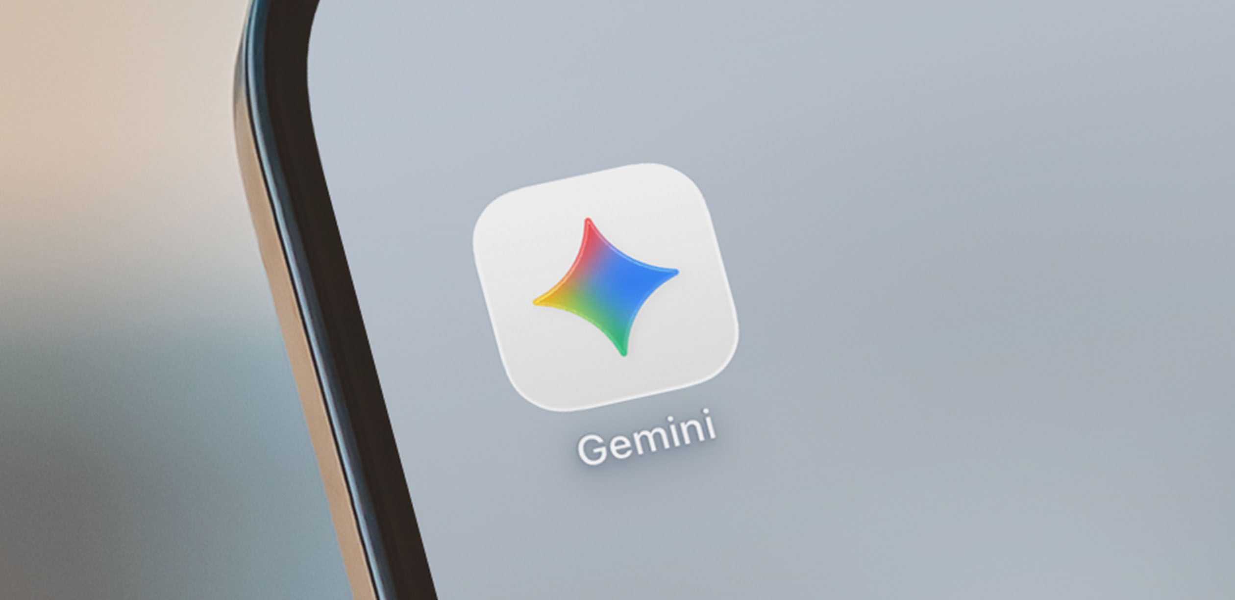 Close-up of a smartphone with Google Gemini app on home screen.