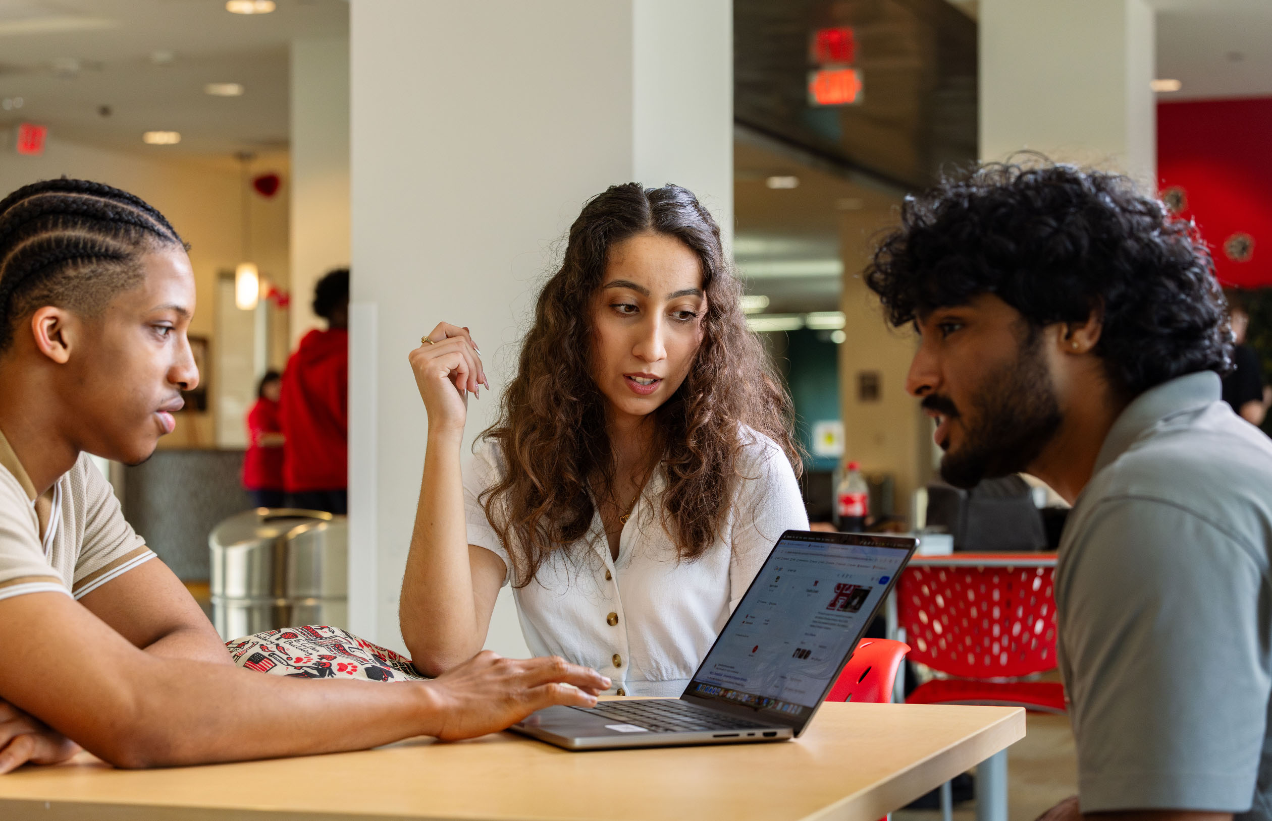 three UH students collaborate together in on-campus housing