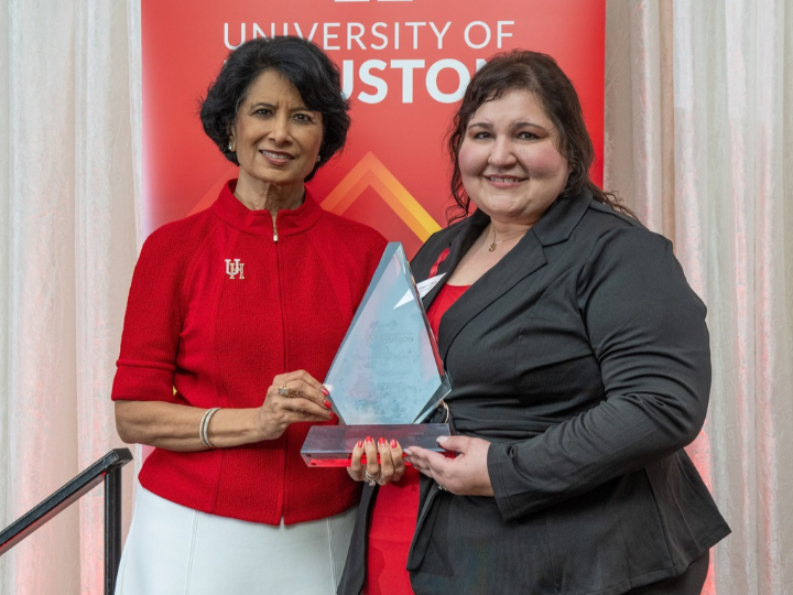 Image of President Renu Khator and C. F. McElhinney Distinguished Service Award winner Stacia Dunn holding her award.
