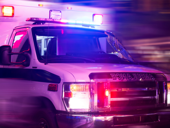 ambulance with lights on driving at night