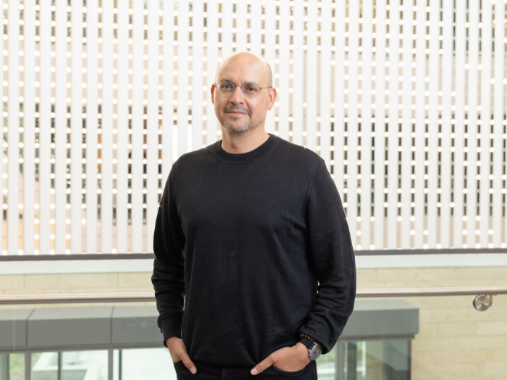 beto lopez standing in the lobby of college of medicine