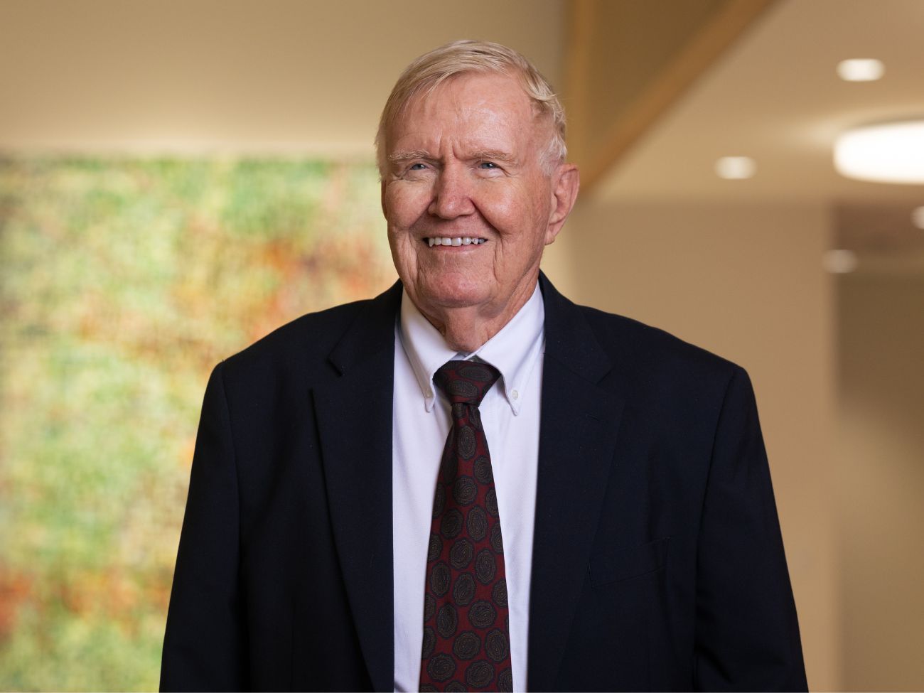 man in suit standing in the uh law center