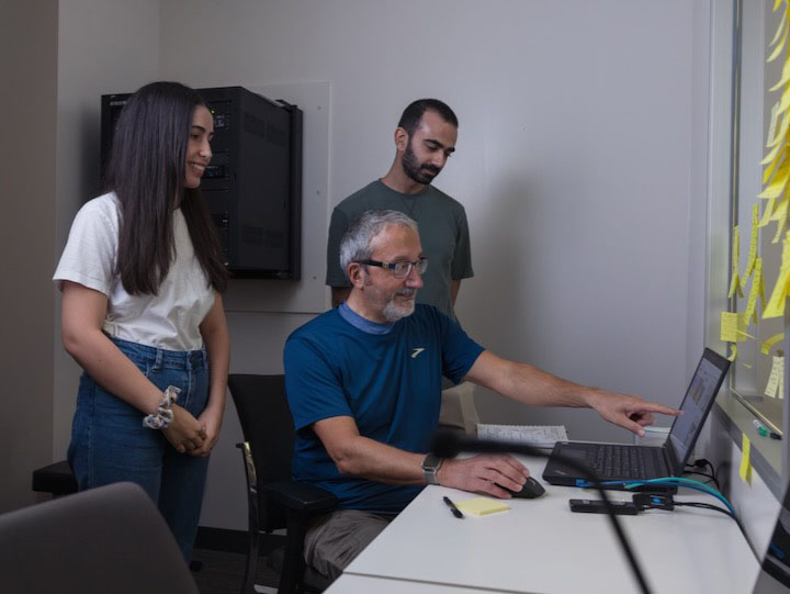 Professor Ioannis Pavlidis (center) works with PhD students in UH’s ACDC Lab.
