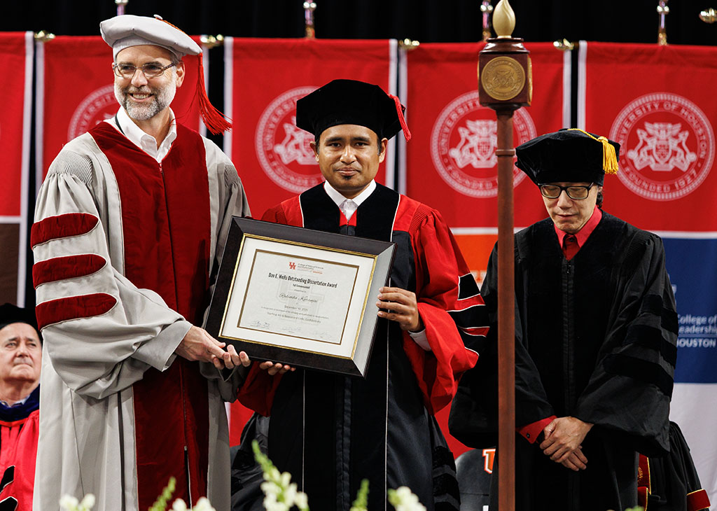Dan E. Wells Outstanding Dissertation Award winner Rabimba Karanjai with Dean Dudley (left) and his advisor Weidong Shi (right).