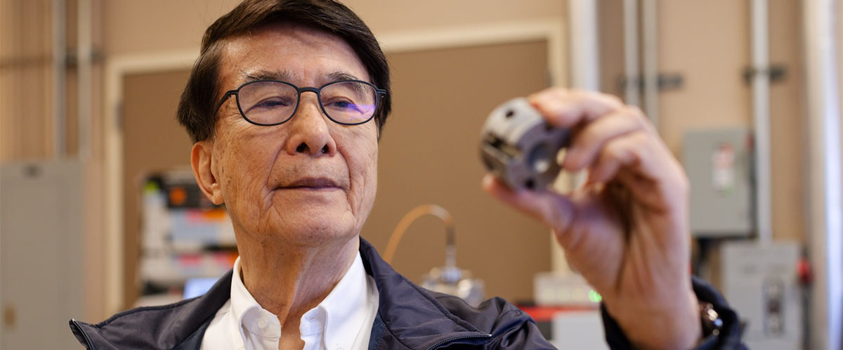 Professor Paul Ching-Wu Chu holds a diamond anvil cell (DAC) in a University of Houston lab. The DAC was used to help the UH team break the temperature record for superconductivity at ambient pressure.